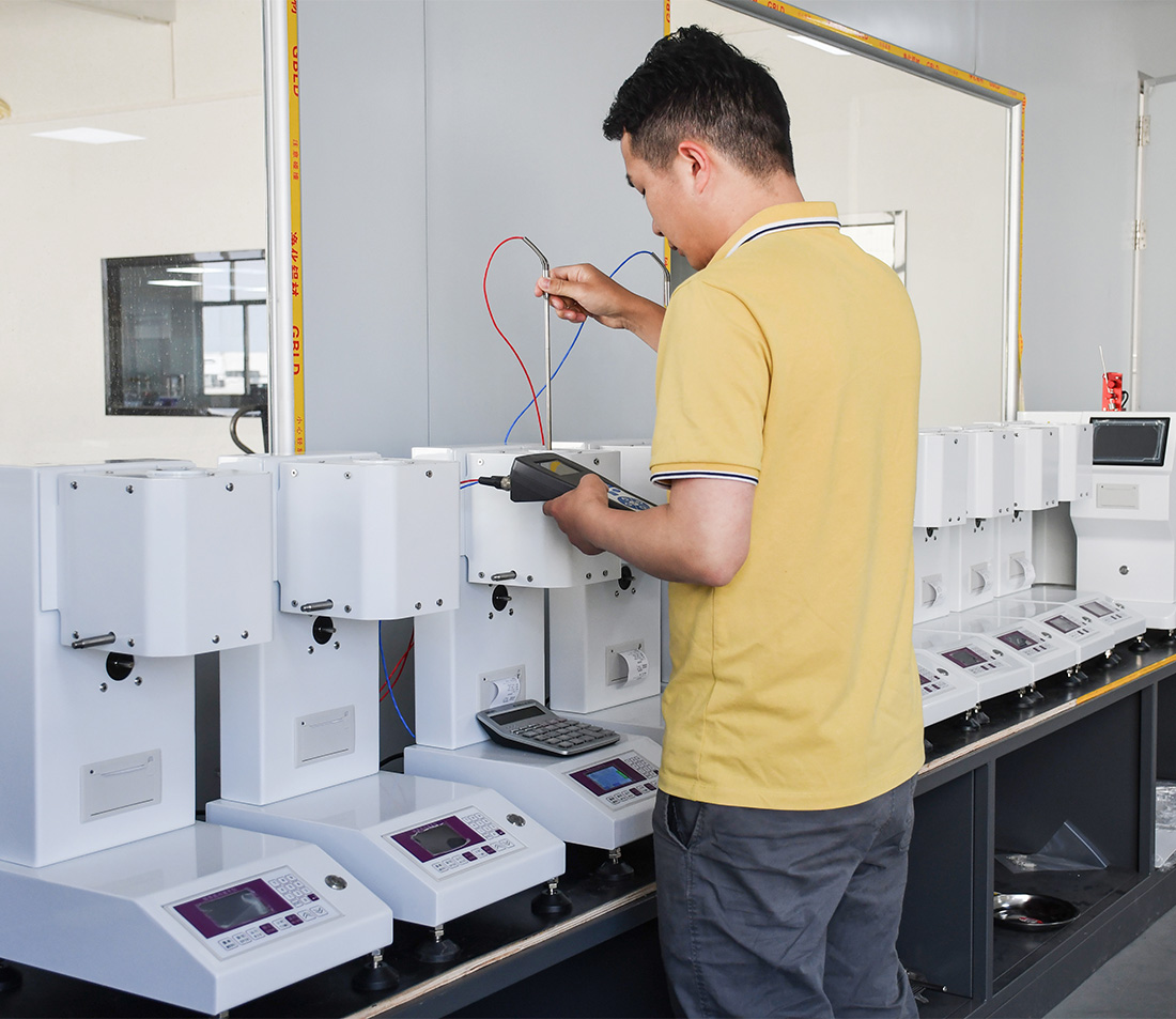 Technician assembling universal tensile testing machine for plastics and rubber testing